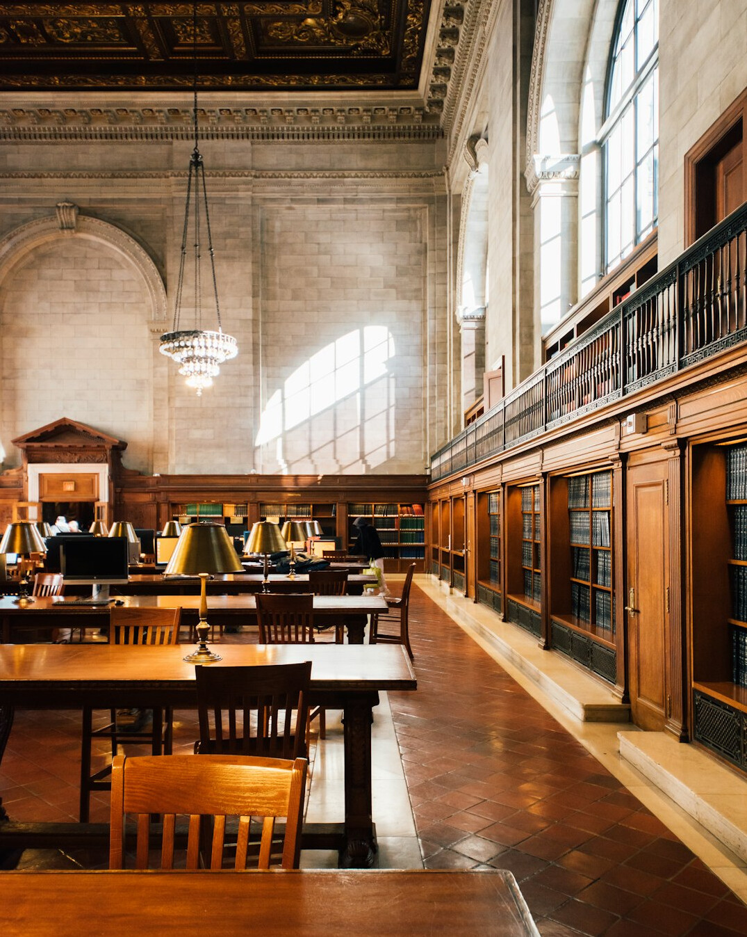 Historic library reading room with rows of books