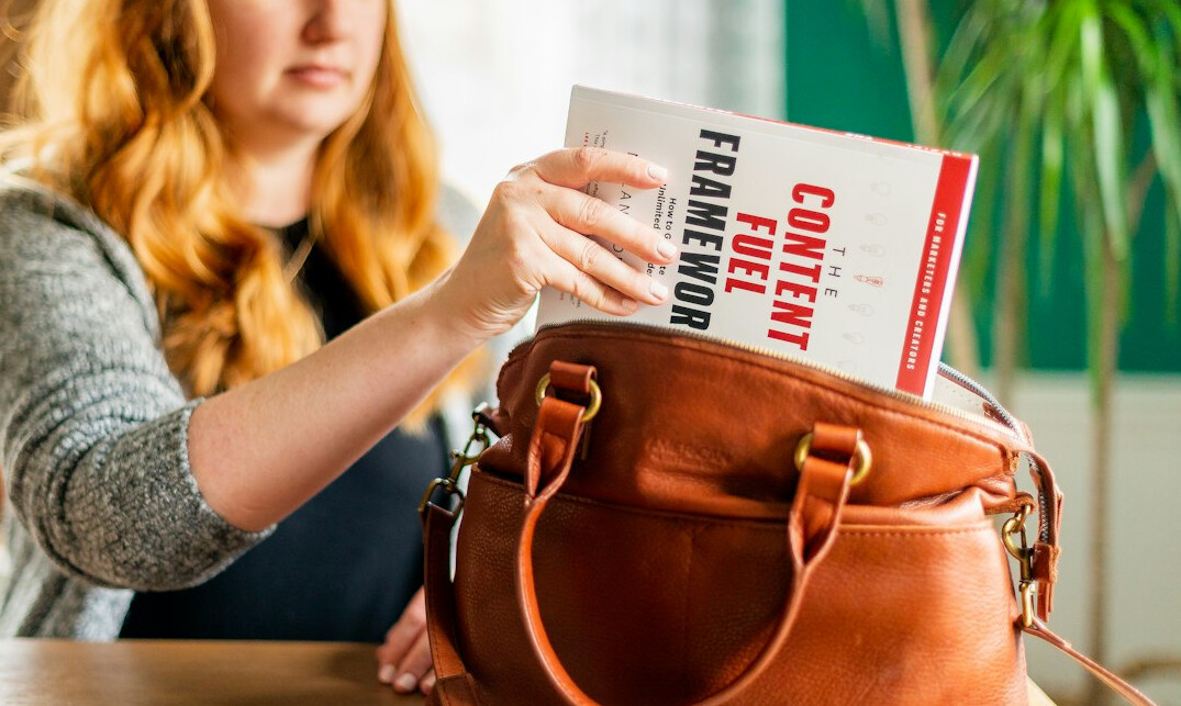 woman hiding item in bag