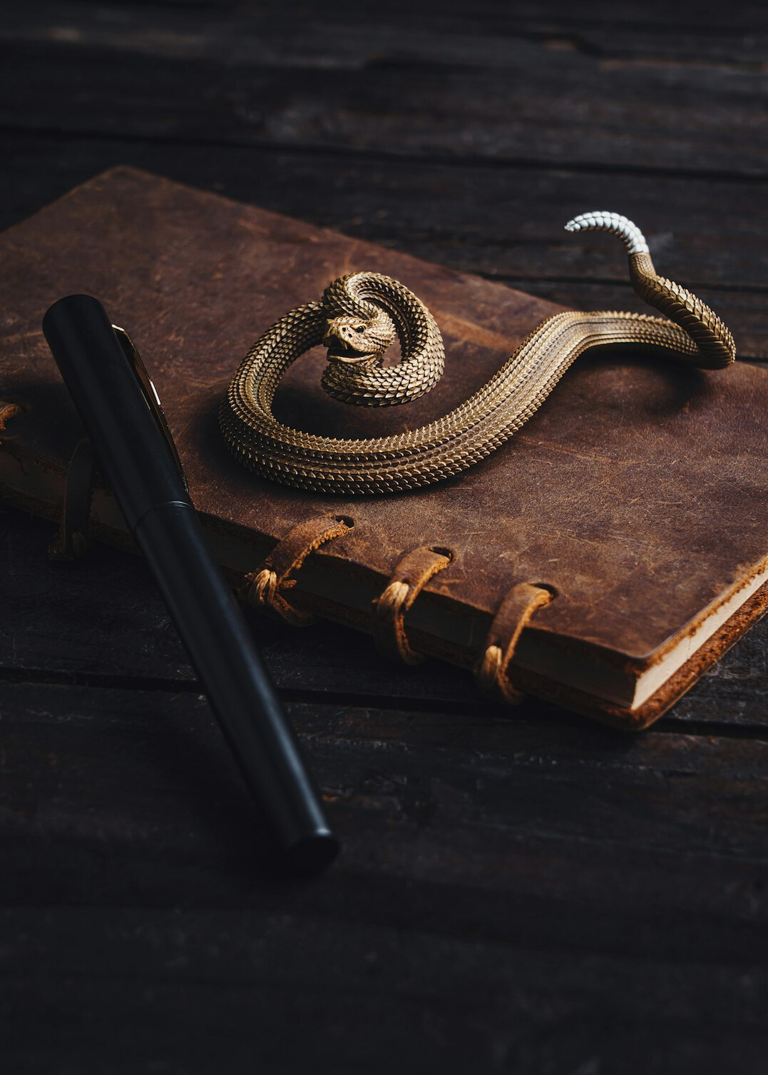 Notebook and pen on a wooden desk, investigation notes